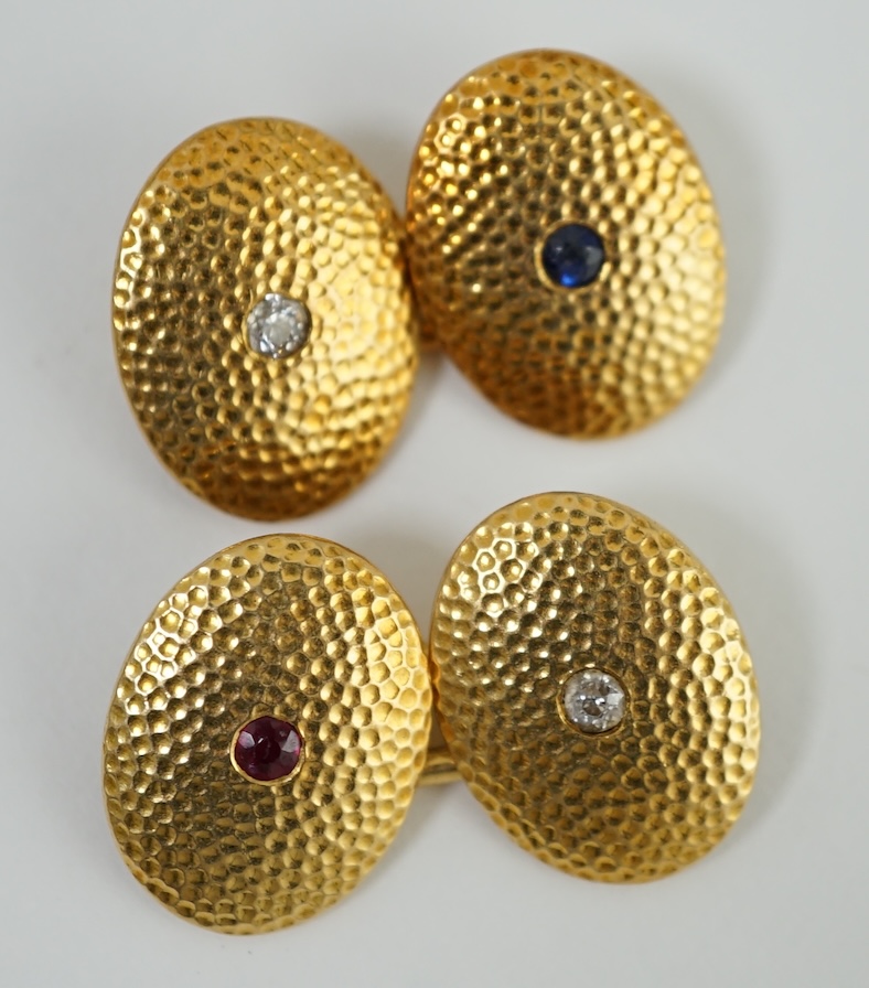 A pair of planished 18ct gold, ruby, sapphire and diamond set oval cufflinks